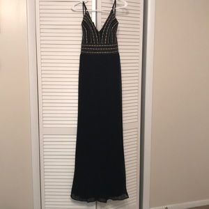 Lulus formal black dress with gold detail.